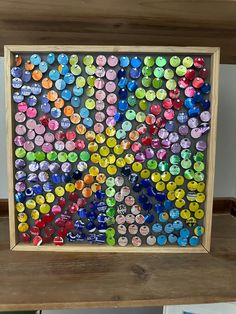 a wooden frame with many different colored buttons on it