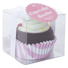 a cupcake with white frosting in a clear box