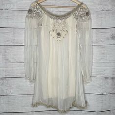 Free People Sheer Lightweight Tunic Mini Dress Could Be Worn On Or Off Shoulder Embellishments And Beading Around Neckline Ruffle Detail At Hem Sheer Long Sleeves Button Detail On Back Unlined Size Xs 30” From Shoulder To Hem Intimately Free People Nude Mini Slip Dress Fitted And Stretchy - 8% Spandex Size Xs/S Bohemian Long Sleeve Sheer Dress, Sheer Flowy Bohemian Dress, Bohemian Style Sheer Flowy Dress, Bohemian Flowy Embellished Dress, Bohemian V-neck Embellished Mini Dress, Bohemian Embellished Mini Dress, Bohemian Embellished Mini Dress For Summer, Boho Tunic Dress, Mini Slip