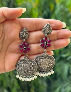 Add charm and elegance to your outfit with these elegant oxidised silver earrings available in beautiful colours. They are eye catching and will add the perfect touch of elegant colour to your outfit. These earrings are very high quality and will last you a lifetime.  They feature carved out flowers which is an ode to the rich heritage of this jewellery rooted in Indian and traditional southeast Asian culture.  These earrings are the perfect pick for a casual ethnic outfit, a regular western fit or when you have an event or festival to attend.  Don't think twice before buying these! These are unique designs and may not be restocked. Please feel free to message in case of a query and we will be happy to help.  Happy shopping! Traditional Silver Flower Earrings For Festive Occasions, Traditional Silver Flower Earrings, Traditional Multicolor Flower Earrings, Silver Oxidised Earrings, Rajput Jewellery, Desi Jewellery, Oxidized Jewellery, Oxidised Earrings, Ethnic Wear Indian