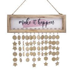 a wooden sign that says make it happen with stars hanging from the front and bottom