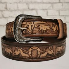 MEN'S LEATHER BELT.Give yourself a gift that you truly deserve! Wear the western leather Belt for Him and show off that sophisticated taste in clothes and accessory while giving off that classic, rodeo vibe. •MADE FROM EXCELLENT QUALITY LEATHER, it comes with pristine genuine leather that is hand-crafted and tested through time.•WITH AN EMBOSSED BULLS & HORSES DESIGN, it shows your true love for the western style giving you that laidback cowboy look.•INCLUDES AN EASY SNAP BACK STRAP DESIGN t Leather Concho Belt Buckles For Rodeo, Western Leather Belt For Western-themed Events, Hand Tooled Leather Belt Buckles For Rodeo, Hand Tooled Leather Belts For Western-themed Events, Hand Tooled Leather Belt Buckles For Ranch, Leather Belt Buckles For Rodeo, Leather Concho Belts For Western-themed Events, Rustic Leather Belt For Rodeo, Rustic Leather Belt Buckles For Rodeo