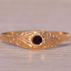 The Swan Hill: Childs Antique Garnet Ring In Yellow Gold. This Ring Centers On A Round Brilliant Cut Natural Garnet. Wrapping The Flush Set Center Stone And Continuing Down The Sides Is A Delicate Engraving. The Ring Is Crafted In 14 Karat Yellow Gold And Is A Finger Size 3.75 Yet Can Be Adjusted To Any Finger Size For An Additional Charge On Request. Antique Garnet Ring, Garnet Ring, Garnet Rings, Womens Jewelry Rings, Round Brilliant, Red Yellow, Garnet, Gold Color, Yellow Gold