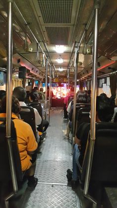 people are sitting on the bus with their backs to each other