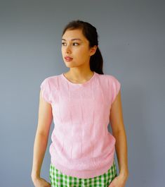 "DESCRIPTION * vintage knitted blouse from 1980s * label Amana for Woolen Mill, made in USA * cropped top style with ribbed waist * pastel pink color * features triangle knit pattern * boat neckline * cap sleeves * tag reads \"Amana/ Made with Pride for Woolen Mills Showroom/ Amana Iowa 52203/ Made in USA\" CONDITION * it is in good vintage condition. Sold as is. ✂------ M E A S U R E M E N T S ------- ✂ Fits like M The shirt is measured by laying flat on a hard surface, it can be stretched out Pastel Pink Color, Knitted Blouse, Sweater Cropped, Cocktail Hat, Kentucky Derby Hat, Hard Surface, Vintage Sweater, Boat Neckline, Knit Pattern