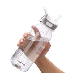 a hand holding a plastic water bottle