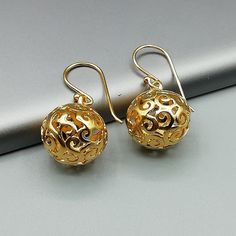 ONE PAIR of filigreed sterling silver ball danglers plated in real gold. Dimensions: 13 mm. Drop length: 28mm These earrings are made of 925 hypoallergenic sterling silver plated in gold. Sent in a gift box. I can include a personal message from you if needed You are welcome to contact me at... bhavnakwintra1956@gmail.com For more beautiful pieces from my shop, please browse 👇 TOE RINGS: https://www.etsy.com/your/shops/TheSilverGame/tools/listings/section:27020628,view:table EAR HOOPS: https:// Elegant Round Christmas Earrings, Elegant Christmas Drop Earrings, Elegant Christmas Celebration Earrings, Gold Round Earrings For Christmas, Elegant Silver Earrings For Christmas, Elegant Silver Christmas Earrings, Gold Spherical Pierced Earrings, Gold Drop Earrings For Christmas, Gold Dangle Earrings For Christmas