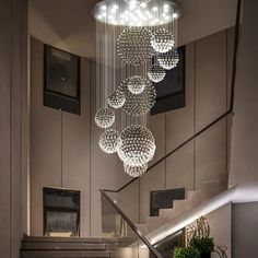 a staircase with chandelier hanging from the ceiling