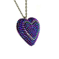 A celestial treasure, the Intergalactic pendant showcases over three hundred colorshifting crystals that shimmer in shades of metallic blue and purple, giving the appearance of a starry night sky from a cosmic distance. DETAILS Heart Charm: 2” wide Chain: 18” chain + 2" extender Made to order. Please allow 1-2 weeks for delivery. SIZE CHART Party Necklaces With Heart Beads And Pendant, Party Necklace With Heart Pendant And Beads, Heart Pendant Bling Jewelry For Party, Crystal Heart Beads Jewelry For Party, Party Jewelry Heart Pendant With Bling, Heart Cut Beaded Necklaces For Party, Heart Pendant Party Jewelry With Bling, Party Heart Pendant Jewelry With Bling, Heart Cut Necklaces With Heart Beads For Party