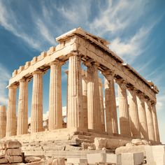 the ruins of an ancient greek temple under a blue sky