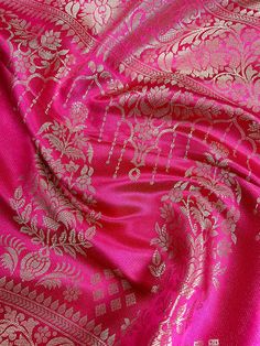 Luxurious Banarasi Mashru silk, renowned for its rich texture and lustrous sheen. The mashru weave combines the elegance of silk, ensuring a graceful drape that feels as good as it looks. A true masterpiece that seamlessly blends traditional craftsmanship with contemporary flair. Featuring a rich Wine with striking Hot Pink Border and Pallu, this saree is perfect for special occasions where you want to make a statement. Item : SareeColor : Wine and Hot PinkBase Fabric : Handloom Banarasi Mashru Silver Silk Traditional Wear For Wedding, Elegant Brocade Blouse Piece With Motifs, Elegant Silver Dupatta For Navratri, Elegant Silver Dupatta For Festivals, Silver Silk Dupatta For Festivals, Silver Bollywood Art Silk Dupatta, Silver Bollywood Style Art Silk Dupatta, Elegant Handloom Pink Lehenga, Silver Raw Silk Traditional Wear For Festive Occasions