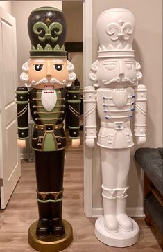 two large nutcrackers are standing next to each other in the hallway,