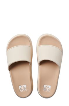 This springy slide sandal offers rebound and cushioning to keep you moving comfortably. Cushioned footbed Water-resistant Synthetic upper, lining and sole Imported Beige Cushioned Slide Flip Flops, Comfortable Beige Slides With Removable Insole, Beige Synthetic Slides With Cushioned Footbed, Spring Open Toe Slides With Gel Cushioning, Comfortable Slide Sandals With Gel Cushioning, Comfortable Slides With Gel Cushioning For Vacation, Synthetic Slip-on Slides With Ortholite Insole, Comfortable Beige Synthetic Slides, Synthetic Slide Slippers With Arch Support