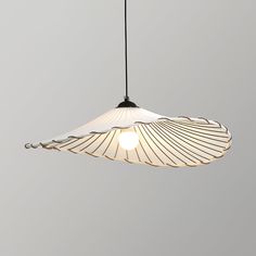 a light that is hanging from the ceiling with a white shade on top of it