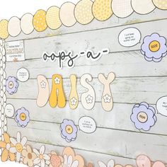 a wooden sign that says daisy with flowers on the bottom and words written in different languages