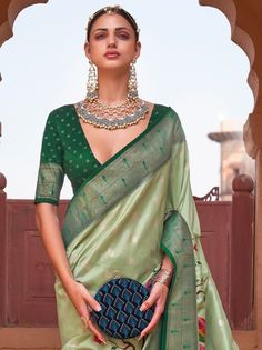 Give yourself a simple but significant look with this adorable light green paithani printed poly silk saree beautified with floral peacock motifs and highlighted with foil print and lovely tassels. This beautiful green paithani saree comes with a dark green color blouse festooned with a foil print. This stunning paithani green saree is 5.50 meters long and comes with fully unstitched 0.80 meters blouse material. Rock the party with this light green paithani printed silk saree and drape the flawl Green Meenakari Blouse Piece For Navratri, Green Blouse Piece With Meenakari For Puja, Green Meenakari Blouse Piece For Puja, Elegant Green Banarasi Silk Blouse Piece, Green Art Silk Blouse Piece With Meenakari, Green Bollywood Blouse Piece With Meenakari, Green Meenakari Art Silk Blouse Piece, Festive Pista Green Blouse Piece For Diwali, Festive Pista Green Blouse For Diwali