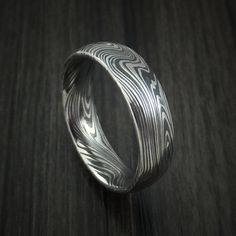 This 6mm wide MARBLED KURO (黒) DAMASCUS ring has a TUMBLE FINISH. Each ring is custom made and the pattern unique, so no two rings are exactly alike. Damascus Steel rings are very desirable. Your ring comes with a COMFORT-FIT for extra satisfaction. Our DAMASCUS ring WILL NOT RUST OR TARNISH.Damascus steel is an ancient art form. This blacksmith alloy is made using two types of Surgical and Fine Stainless steel that are layered in 100 alternating layer and then worked. It is then twisted and fol Damascus Mens Wedding Bands, Damascus Rings For Men, Damascus Wedding Band Men, Damascus Steel Wedding Band, Butterfly Engagement Ring, Delicate Gold Ring, Damascus Ring, Damascus Steel Ring, Rings Men