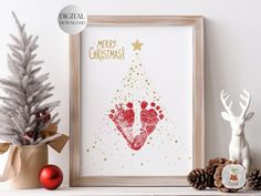 a christmas card with a handprinted heart in the shape of a baby's foot