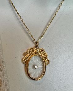 So my trek out to our little Florida town with all the antique shops has begun! I've scored a few nice pieces I'll be posting soon. This is a beautiful vintage gold tone fancy filigree camphor glass with sparkly crystal gold tone necklace. Jewelers made camphor glass to imitate the carved rock crystal quartz that was popular from the mid-nineteenth century through the 1930s.  It's made by treating clear glass with hydrofluoric acid vapors to get the frosted finish look. Old and new pieces are making a big come back in the jewelry collecting and fashion world. The center crystal here looks like a shiny diamond if you didn't know it was a crystal! Great price for a great piece that's looks like a family heirloom. It has a dainty gold tone 18.5 necklace. I'll send along an extender in case yo Edwardian Jewelry Necklaces, Family Heirloom Jewelry, Camphor Glass Jewelry, Posting Soon, Small Business Gifts, Stained Glass Jewelry, Edwardian Jewelry, Filigree Necklaces, Unique Handmade Jewelry