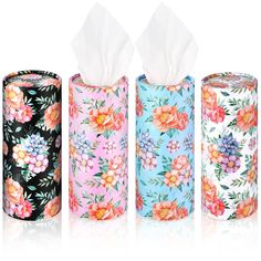 three rolls of toilet paper with floral designs on them and one roll in the middle