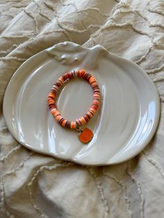 a white plate with a bracelet on it