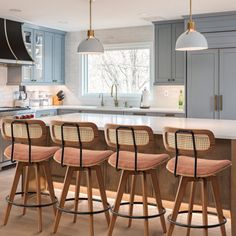 a kitchen with blue cabinets and wooden stools