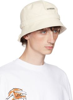 Cotton twill bucket hat in off-white. · Logo hardware at face · Quilted brim · Self-tie drawstring at back face · Cotton poplin lining Part of the Les Classiques collection. Supplier color: Off-white Beige Canvas Bucket Hat, Beige Canvas Hats For Spring, Beige Canvas Bucket Hat For Summer, Beige Canvas Spring Hats, Summer Beige Canvas Bucket Hat, Spring Beige Canvas Hats, Cream 5-panel Summer Hat, White Curved Brim Canvas Hat, Casual Beige Canvas Bucket Hat