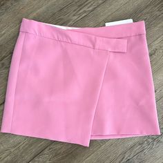 Flowy Fabric. Crossover Design. Short Design. Straight Design. Medium Waist. Button Fastening On The Front. Inner Lining. Co-Ord. College. Office Looks. Runs Big. I’m Usually A 4-6 Button Closure Chic Pink Skort For Workwear, Pink Short Length Skort For Work, Pink Skort For Workwear, Pink Skort For Spring Workwear, Chic High-waisted Pink Skort, Chic Pink Skort, Chic Summer Skort With Buttons, Pink Workwear Skirt With Buttons, Pink Buttoned Workwear Skirt