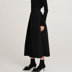 The black ankle-length Messina wool skirt is an elegant and classic piece of clothing. It is crafted from high-quality wool on a viscose lining. There are pleats at the front and back, which add volume and elegant shape to the skirt. Pockets in the side seams are a practical but discreet addition. Such a model combines classics with comfort and attention to detail, perfectly matching formal and casual styling. Main fabric: Wool 98%, Elastane 2% Lining: Viscose 100%    Dry cleaning only Polish Clothing, Animal Print Party, Knit Loungewear, Skirt Pockets, Stocking Fillers For Her, Fabric Wool, Holiday Party Outfit, Black Midi, Wool Skirt