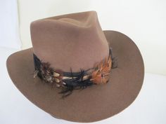 "Vintage Tiger of Sweden Outback Style Hat Made by Gil Truedsson Out of a ranch here in the Sierra's Top notch. For your steppin' out hat... Spectacular and extraordinary hat for the stylin' guy 5\" high 3\" brim. Feather hat band 23\" The color is a beautiful brown White satin lining Interior band is leather Excellent condition...barely worn Don't miss this one! Sharp! https://www.etsy.com/shop/BelindasStyleShop" Brown Southern Style Hat For Rodeo, Vintage Flat Bill Hat For Country Events, Fitted Brown Country Style Top Hat, Southwestern Brown Hat With Short Brim, Brown Flat Bill Hat For Western-themed Events, Brown Southwestern Hat With Short Brim, Southwestern Brown Fedora Hat, Fitted Brown Country Hat Bands, Southern Style Brown Hat With Curved Brim