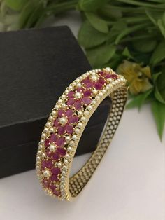 Material:  brass, CZ Stones, Pearl  Suitable for any kind of outfit like lehenga Kurtis Denims Sarees and Gowns.  Suitable for any occasions and ceremonies.  Arrives in a small plastic box.  Best gift for your anniversary. Best gift for her Birthday. Bracelet : 1 Elegant Bangle For Diwali Celebration, Pink Cutdana Bracelets For Festivals, Elegant Cutdana Bangle For Diwali, Festive Pink Cutdana Bracelets, Festive Celebration Bangle Bracelet, Elegant Bracelets For Diwali Celebration, Bollywood Style Bracelets For Festive Weddings, Bollywood Style Bracelets For Festive Wedding Occasions, Bollywood Style Bracelets For Wedding And Festive Occasions