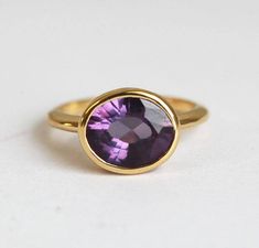 Amethyst wedding ring. 18k solid gold round shaped cut. Financing available. Buy engagement rings at affordable price from Capucinne Jewelry. FREE insured shipping worldwide! Oval Amethyst Ring, Amethyst Wedding Rings, Amethyst Rings, Silver Ruby Ring, February Birthstone Ring, Amethyst Wedding, Gold Amethyst Ring, Buying An Engagement Ring, Diamond Fashion Rings