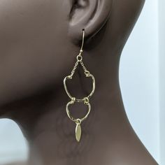 The stunning Amu Earrings! These elegant and lightweight dangle earrings feature a chic hook design made from high-quality brass metal and finished with a beautiful platino goldtone. You'll feel confident and stylish wearing these versatile earrings for any occasion. Don't sacrifice comfort for fashion - make a statement with the Amu Earrings today! Dangle style hook earrings Brass metal Platino goldtone Chic and elegant Lightweight Weight 6 grams Length 3.07 inches Handcrafted artisan radiant b Chic Gold-tone Metal Earrings, Trendy Gold Metal Earrings, Trendy Gold Dangle Hoop Earrings, Modern Gold Plated Earrings With Ear Wire, Elegant Gold-tone Pierced Plug Earrings, Elegant Gold-tone Plug Earrings, Trendy Yellow Gold Metal Earrings, Gold-tone Everyday Earrings, Elegant Gold Plug Earrings In Brass