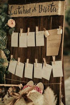 a wooden sign with lots of notes attached to it