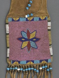 an old beaded and leather purse with tassels