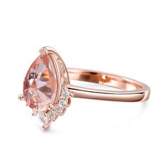 This captivating engagement ring features an enchanting pear-shaped morganite that radiates blushing hues at the center. Sparkling round stones dance down the band, which is fashioned in romantic rose gold tone sterling silver.Carat Weight: 1.815 ctStone Size: 7*10 mmNumber of Stones: 1 Stone Shape: PearStone Color: Fancy PinkCarat Weight: 0.7 ctStone Size: 2*3,1.5 mmStone Type: Jeulia® StoneNumber of Stones: 9 Stone Shape: Pear, RoundStone Color: Diamond WhiteWeight: 3.1 gWidth: 2.66 mmHeight: 5.9 mmThickness: 1.2 mmMaterial: 925 SilverPlating Color: Rose Gold Pear-shaped Rose Gold Ring For Proposal, Rose Gold Pear-shaped Ring For Proposal, Pear-shaped Rose Gold Proposal Ring, Elegant Teardrop Morganite Rings, Rose Gold Teardrop Ring For Proposal, Elegant Pink Teardrop Ring, Pear Shaped Pink Ring For Formal Occasions, Pink Pear-shaped Ring For Formal Occasions, Elegant Peach Ring For Anniversary