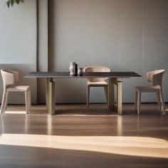 a table and chairs in a room with a plant on the wall next to it