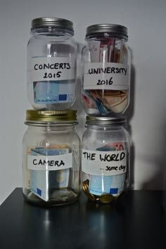 three jars with labels on them sitting on a table