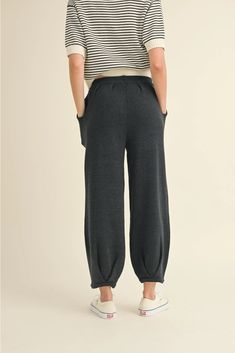 Women's Loose Pleated Joggers Drawstring Knit Lounge Pants Introducing our latest arrival: Drawstring Knit Lounge Pants! Available in two trendy colors, these pants boast a drawstring, convenient side pockets, pleated accents, and a cozy jogger style. Made with soft ribbed fabric, you'll never want to take them off. With a cute, cozy, and chic aesthetic, these pants feature a loose fit for maximum comfort. Complete the look by pairing them with our matching shirt (sold separately). Trust us, you Fall Ankle-length Sweatpants With Drawstring, Casual Bottoms With Elastic Side Panels For Fall, High-waisted Harem Pants For Loungewear, Wide Leg Drawstring Joggers For Fall, Cozy Bottoms With Elastic Cuffs For Fall, Casual Fall Pants With Elastic Side Panels, Cozy Fall Bottoms With Pockets, Fall Loungewear Ankle-length Harem Pants, Fall Sweatpants Pull-on Style