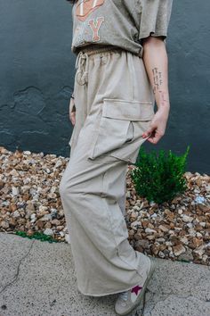 Get ready to slay the day with these Effortless Behavior Khaki Pants! With a stylish drawstring and wide leg cargo design, these pants will keep you looking on-trend while also being ultra-comfortable. The mineral wash adds a unique touch to your wardrobe. Perfect for any casual or dressy occasion, these pants are a must-have! *lighting may differ the color Utility Style Sweatpants For Loungewear, Utility Sweatpants With Pockets For Loungewear, Utility Sweatpants With Drawstring For Loungewear, Utility Style Drawstring Sweatpants For Loungewear, Utility Drawstring Sweatpants For Loungewear, Spring Loungewear Sweatpants With Cargo Pockets, Parachute Pants With Cargo Pockets For Loungewear, Relaxed Fit Wide Leg Cargo Harem Pants, Relaxed Fit Lounge Pants With Multiple Pockets