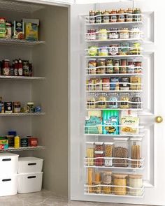 the pantry door is open to reveal an assortment of food items and containers in it