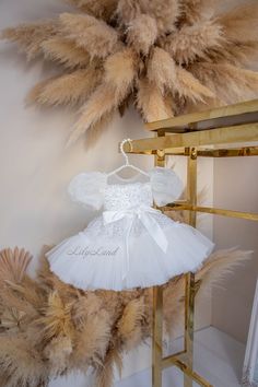 Hello! 🌟 Impressive beauty and enchantment - that's what makes our new collection of children's festive dresses so exceptional. Allow me to introduce our refined and elegant ensemble for your little princess. This children's festive dress captivates with its sophistication and detailing. The voluminous tutu made of tulle adds an air of lightness and grace to the ensemble, while the lavish sleeves crafted from organza give the attire a touch of refinement. The top and skirt of this dress are adorned with a sparkling layer of sequins, creating the effect of a true festive spark. This shimmer and proximity to a fairytale glow make your little one the unrivaled star of any celebration. Special attention is drawn to the waist, adorned with a satin bow. It not only adds elegance but also accent Fitted White Dress For Birthday, White Fitted Dress For Birthday, Spring Princess Dress For Celebration, Princess Dress For Spring Celebration, Princess Style Dress For Spring Celebration, Spring Celebration Princess Dress, Holiday Princess Dress With Ruffles For Baptism, Holiday Ruffles Princess Dress For Baptism, Holiday Baptism Princess Dress With Ruffles