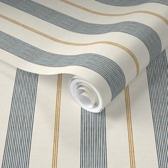 a white and blue striped wallpaper with gold lines on the bottom half of it