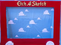 a child's drawing frame with clouds on it and the words etch - a - sketch