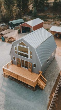 an aerial view of a house with two garages and a deck in the foreground