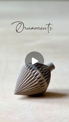 an origami bird sitting on top of a wooden table next to the words ornaments