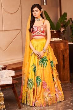 Yellow can can attached lehenga featuring thread embroidered patchwork floral and nature motifs, embellished by sequins. Comes with padded embroidered strappy blouse and dupatta. - Aza Fashions Designer Yellow Sets With Motifs, Designer Yellow Choli With Motifs, Yellow Choli With Floral Embroidery For Reception, Bohemian Lehenga With Floral Embroidery And Traditional Drape, Designer Yellow Lehenga With Floral Embroidery, Yellow Floral Embroidered Lehenga For Navratri, Yellow Lehenga With Floral Embroidery For Navratri, Fitted Yellow Lehenga With Motifs, Navratri Yellow Lehenga With Floral Embroidery