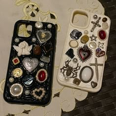 two cell phones sitting next to each other on top of a white cloth covered table