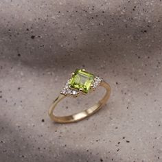 Guaranteed to take your breathe away, the princess cut peridot stone at the core of the Juliette is serene. The peridot is adorned with 10 dazzling white diamonds, contributing extra glamour to the ring. The elegance of this piece is incomparable as it radiates royalty and allure. All features can be customized! Please contact us if you wish to make changes, we love making custom designs. All of our jewelry is carefully handmade in our atelier. *HC diamond are all conflict-free diamonds To order by phone 972-72-2991000 Peridot Diamond Ring, Letter Bracelet, Peridot Stone, Pendant Rings, Bracelet Collection, Girls Earrings, Diamond Bracelets, The Princess, White Diamonds