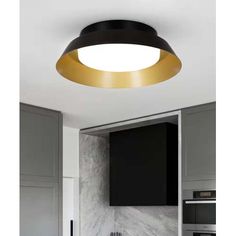 an image of a modern kitchen setting with black and gold lighting in the ceiling light